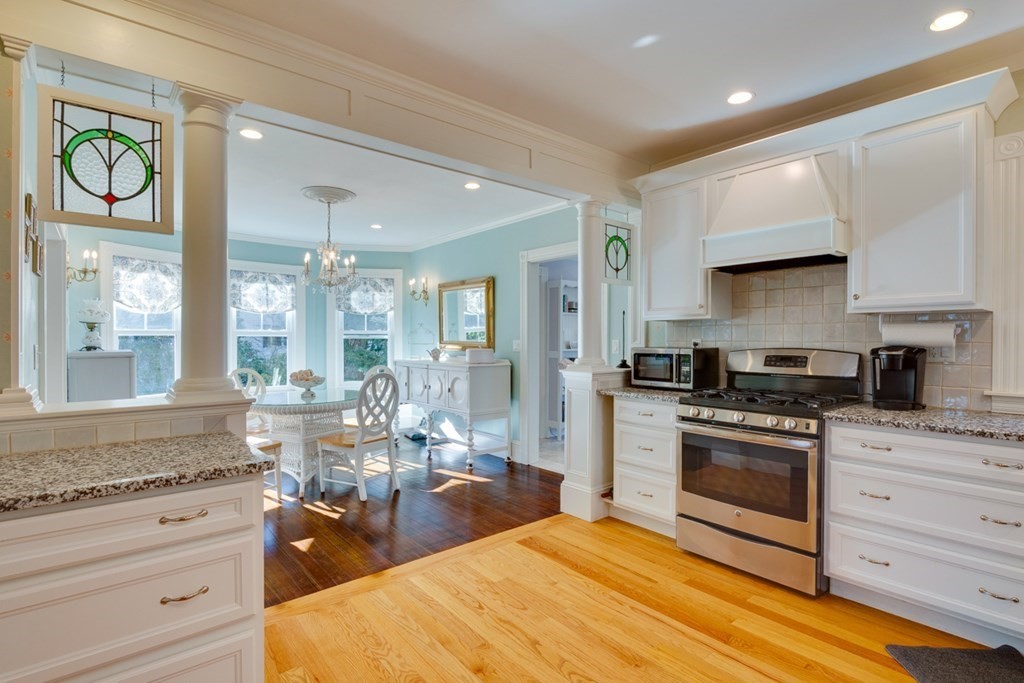 227 Warren Street Needham, MA 02492 - Photo 11 of 36 a large kitchen with stainless steel appliances granite countertop a stove and a sink
