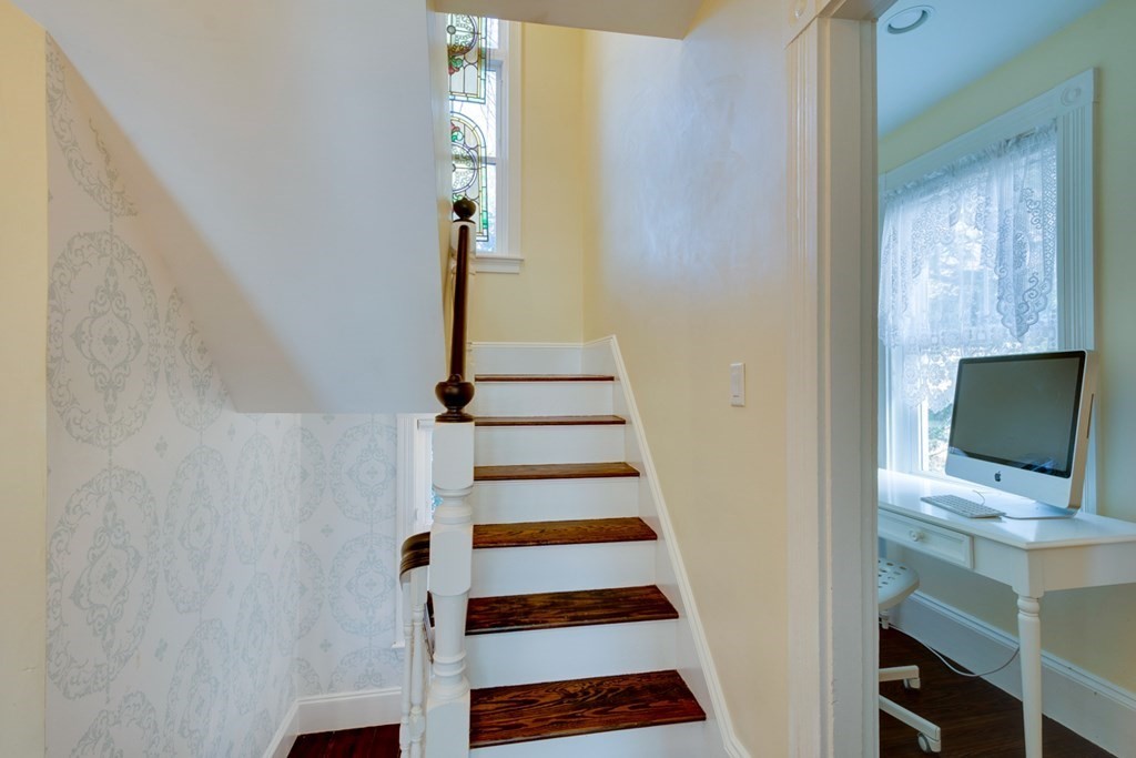 227 Warren Street Needham, MA 02492 - Photo 16 of 36 a view of a hallway with front door wooden floor and front door
