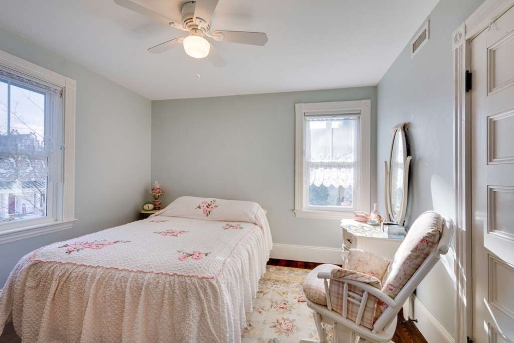 227 Warren Street Needham, MA 02492 - Photo 17 of 36 a bedroom with a bed and a chandelier