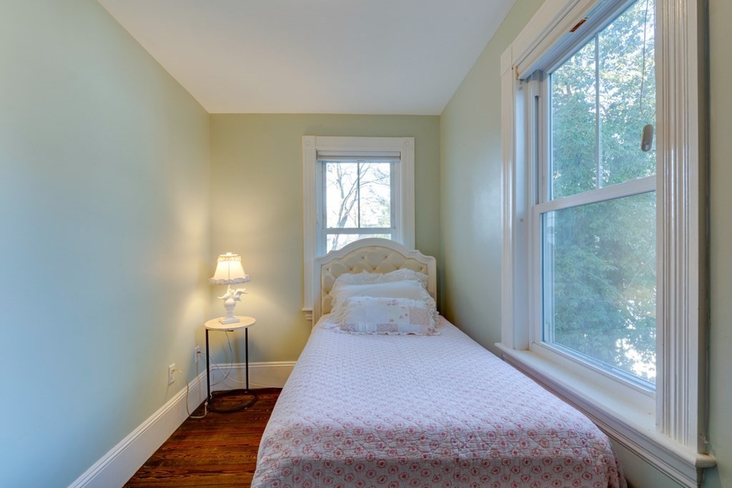 227 Warren Street Needham, MA 02492 - Photo 18 of 36 a bedroom with a bed and wooden floor