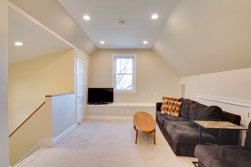227 Warren Street Needham, MA 02492 - Photo 21 of 36 a living room with furniture and a flat screen tv