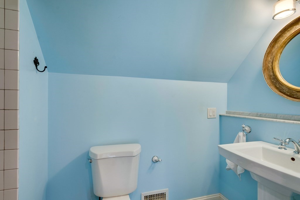 227 Warren Street Needham, MA 02492 - Photo 23 of 36 a bathroom with a sink a toilet and a mirror