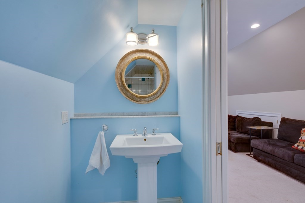 227 Warren Street Needham, MA 02492 - Photo 24 of 36 a bathroom with a sink and a mirror