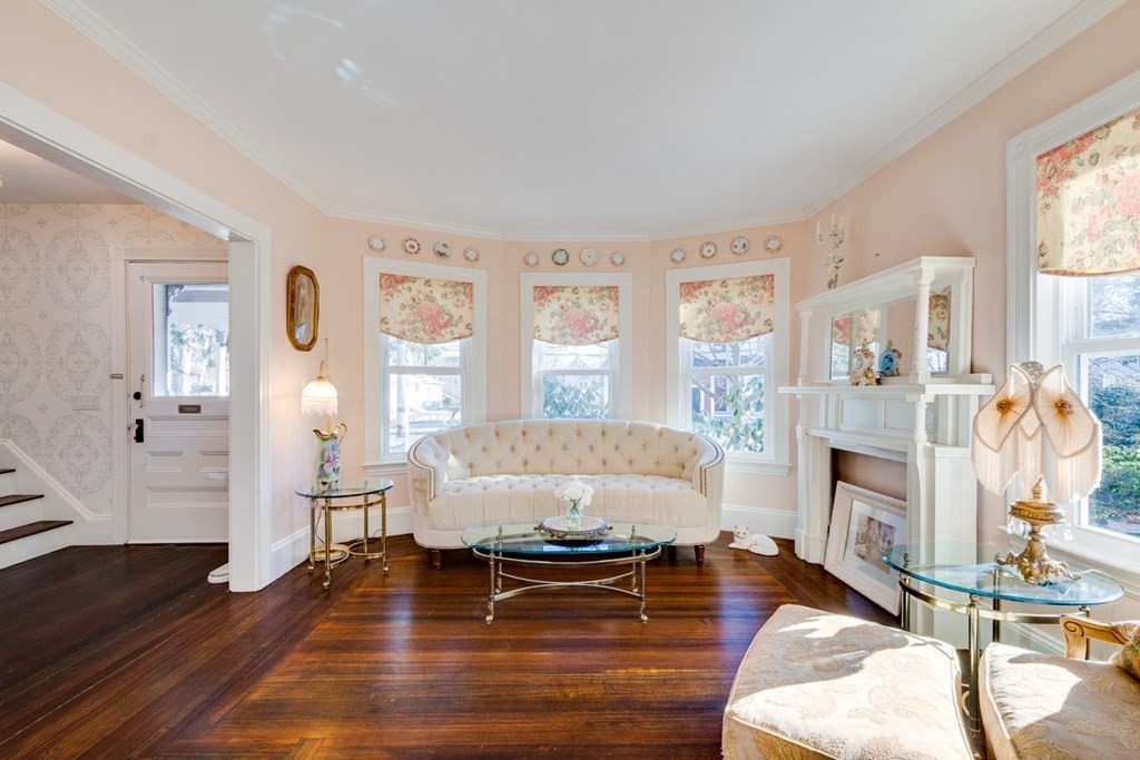 227 Warren Street Needham, MA 02492 - Photo 4 of 36 a living room with fireplace furniture flat screen tv and window