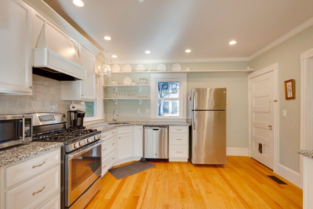 227 Warren Street Needham, MA 02492 - Photo 9 of 36 a kitchen with stainless steel appliances a refrigerator sink and stove