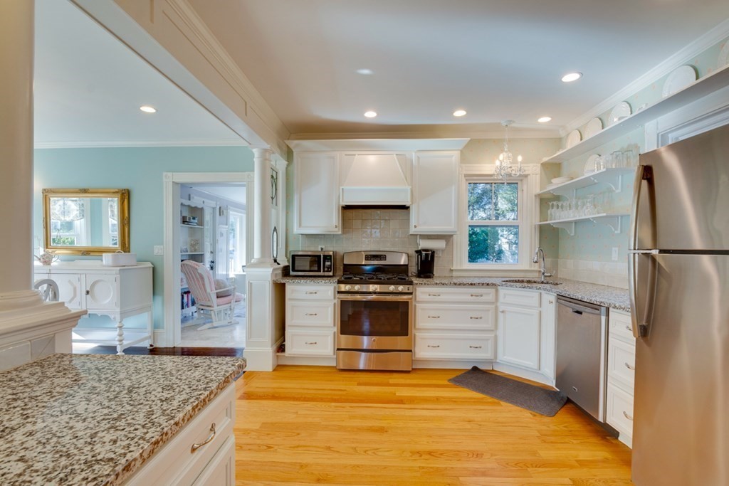 227 Warren Street Needham, MA 02492 - Photo 10 of 36 a kitchen with stainless steel appliances granite countertop a refrigerator sink and stove
