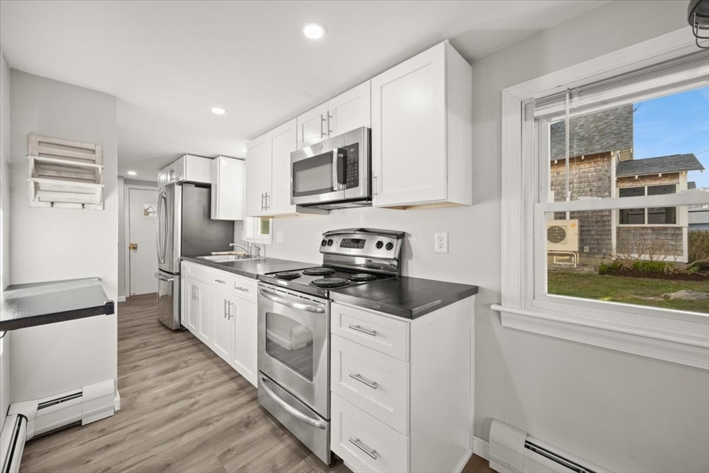 24 Harvard Street Fairhaven, MA 02719 - Photo 19 of 31 a kitchen with stainless steel appliances granite countertop a stove a sink and a refrigerator