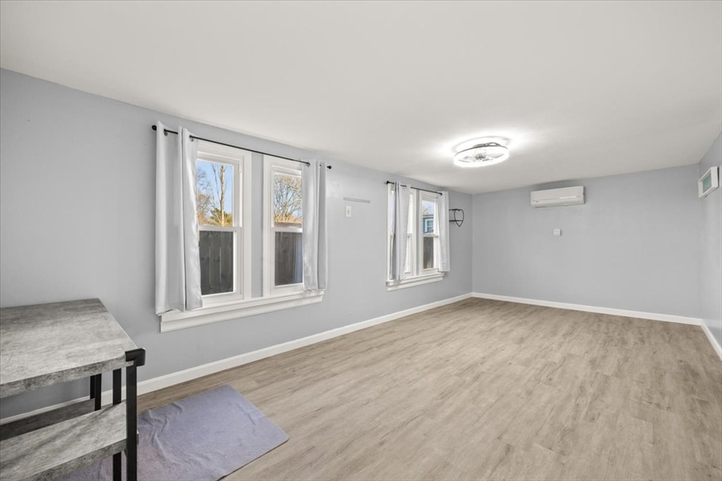 24 Harvard Street Fairhaven, MA 02719 - Photo 27 of 31 a view of an empty room with wooden floor and a window