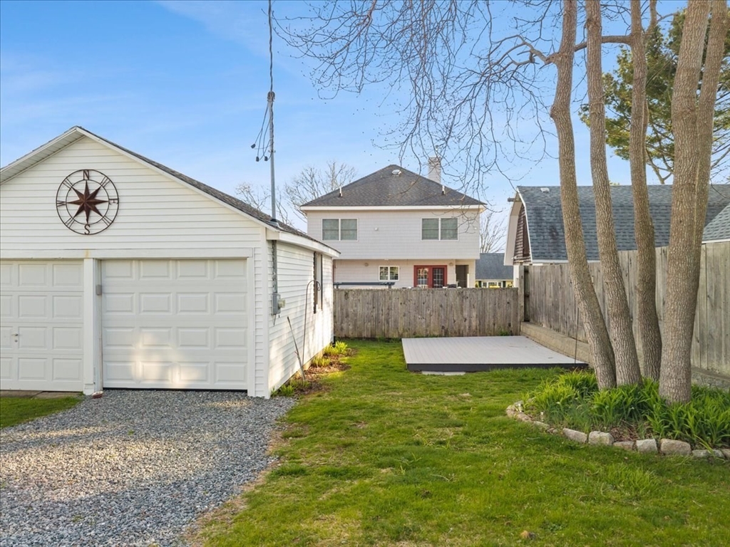 24 Harvard Street Fairhaven, MA 02719 - Photo 5 of 31 a front view of a house with a yard and garage