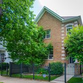 front view of a house with a tree