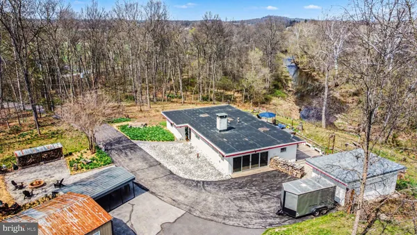 an aerial view of a house with a yard