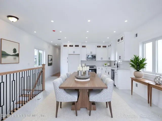 an empty room with a white wall and natural light