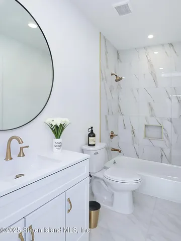 an empty room with wooden floor and window