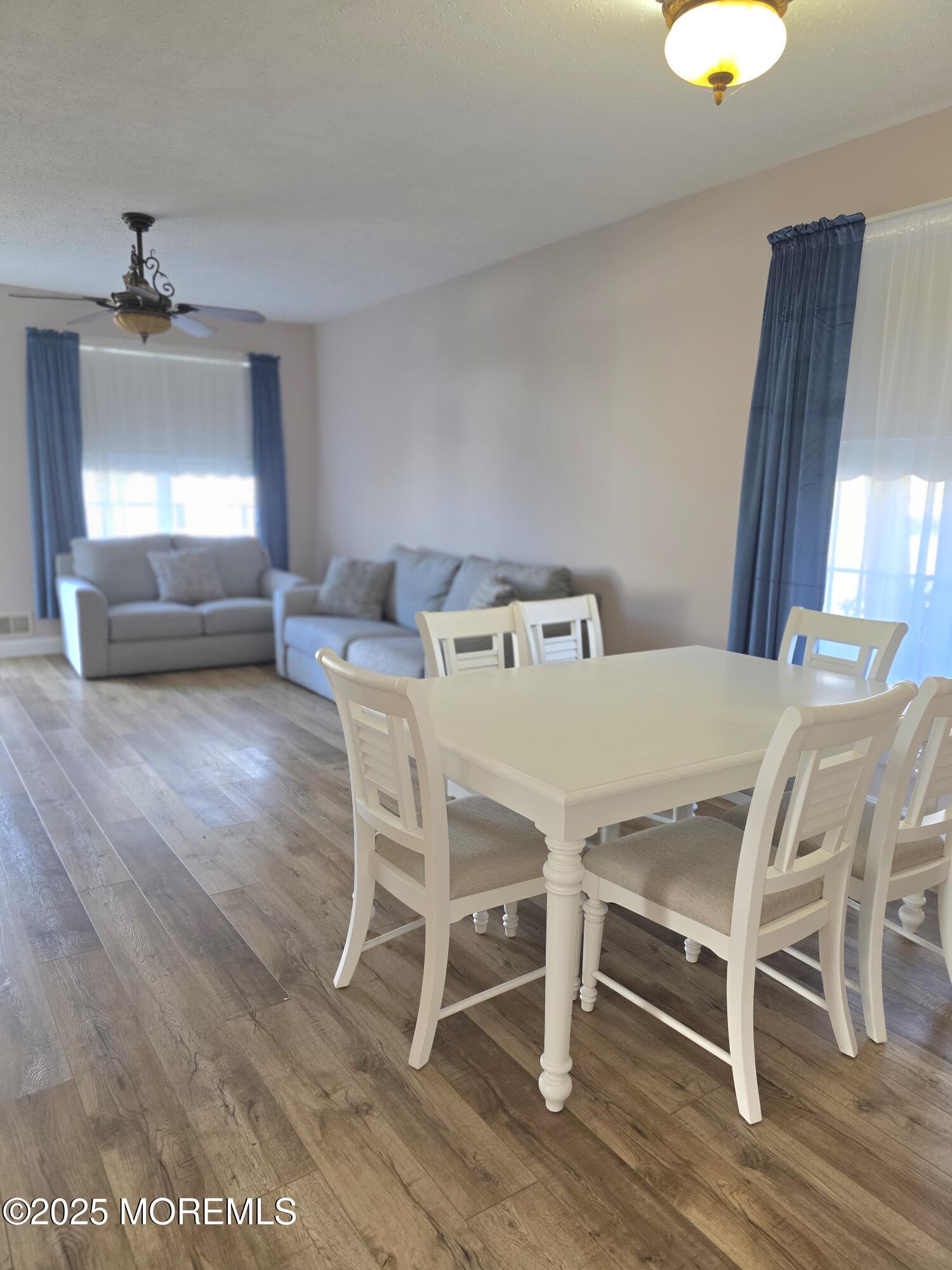 61 Sandpiper Road Barnegat, NJ 08005 - Photo 20 of 44 a view of a dining room with furniture and wooden floor