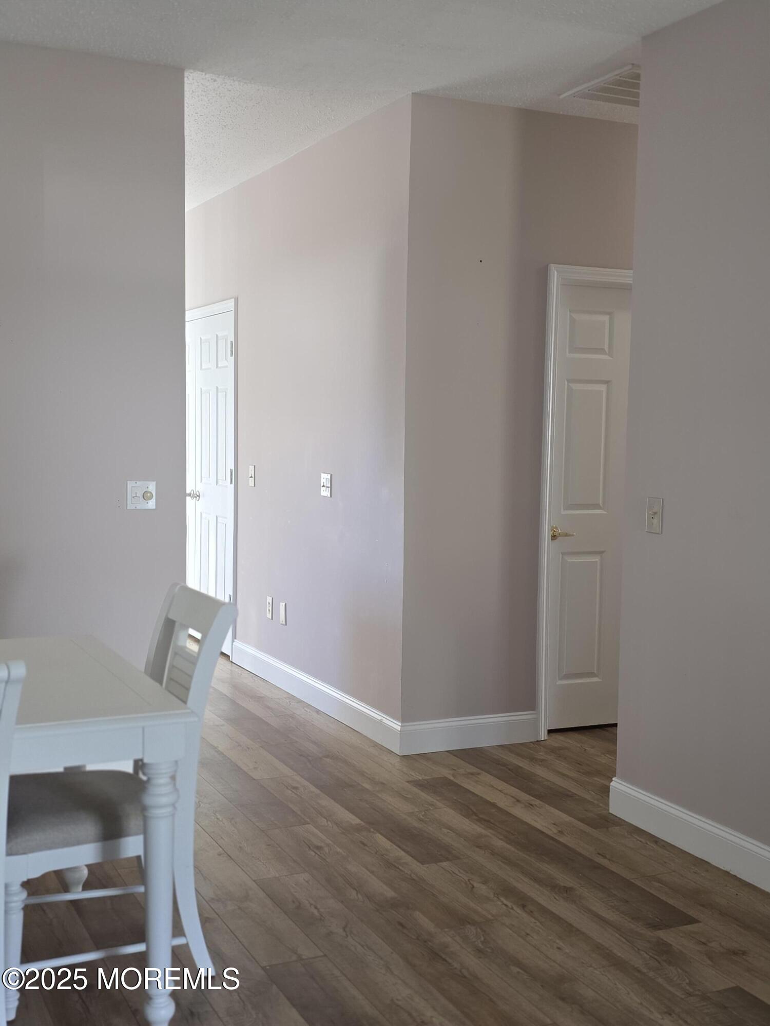 61 Sandpiper Road Barnegat, NJ 08005 - Photo 21 of 44 an empty room with wooden floor and mirror