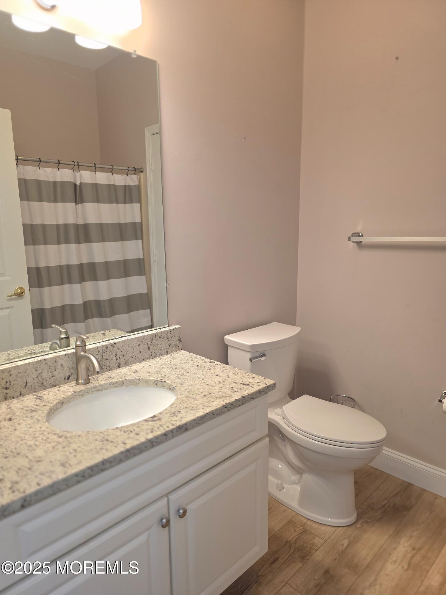 61 Sandpiper Road Barnegat, NJ 08005 - Photo 23 of 44 a bathroom with a granite countertop sink a toilet and a mirror
