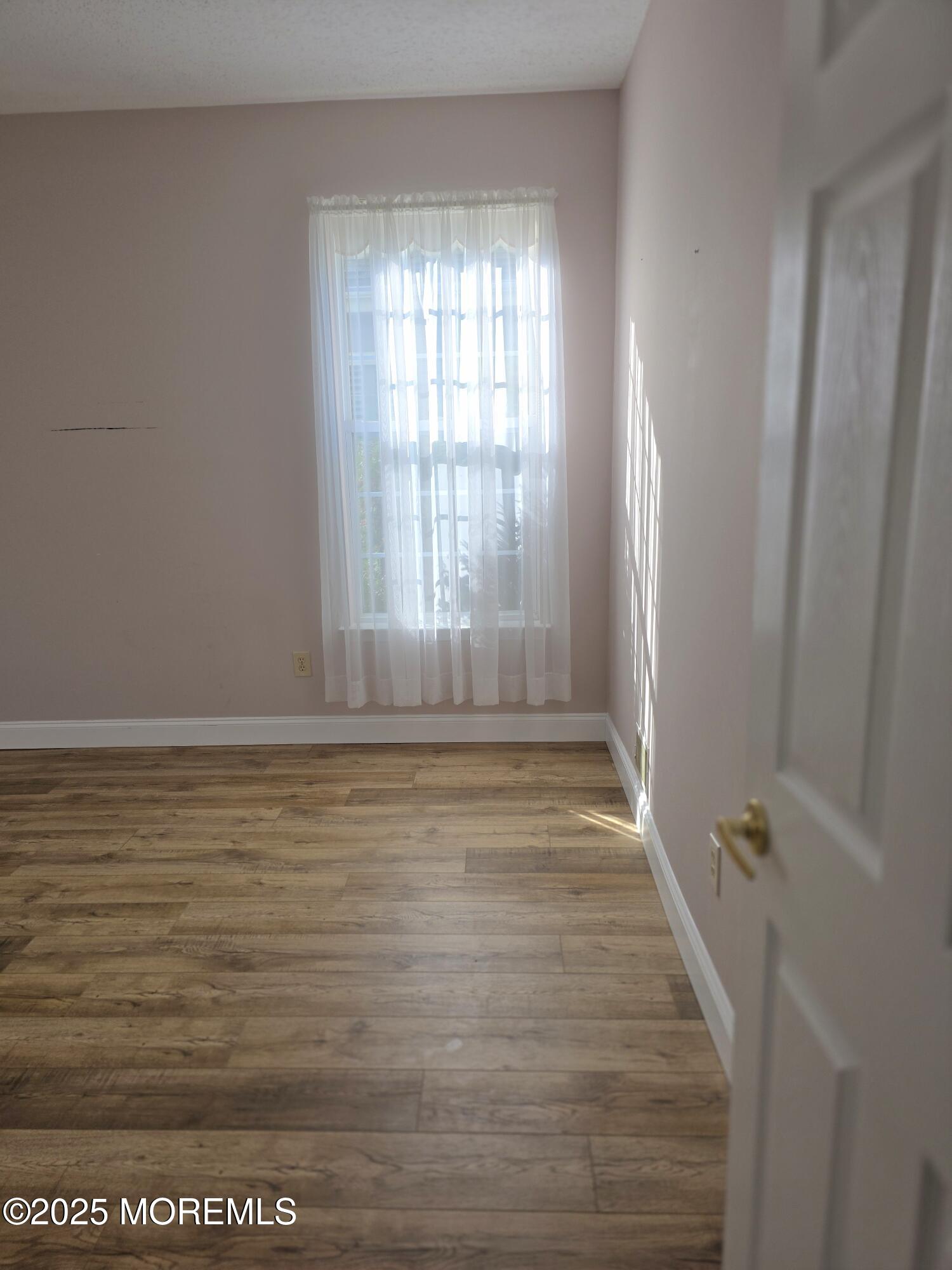 61 Sandpiper Road Barnegat, NJ 08005 - Photo 28 of 44 a view of an empty room with a window