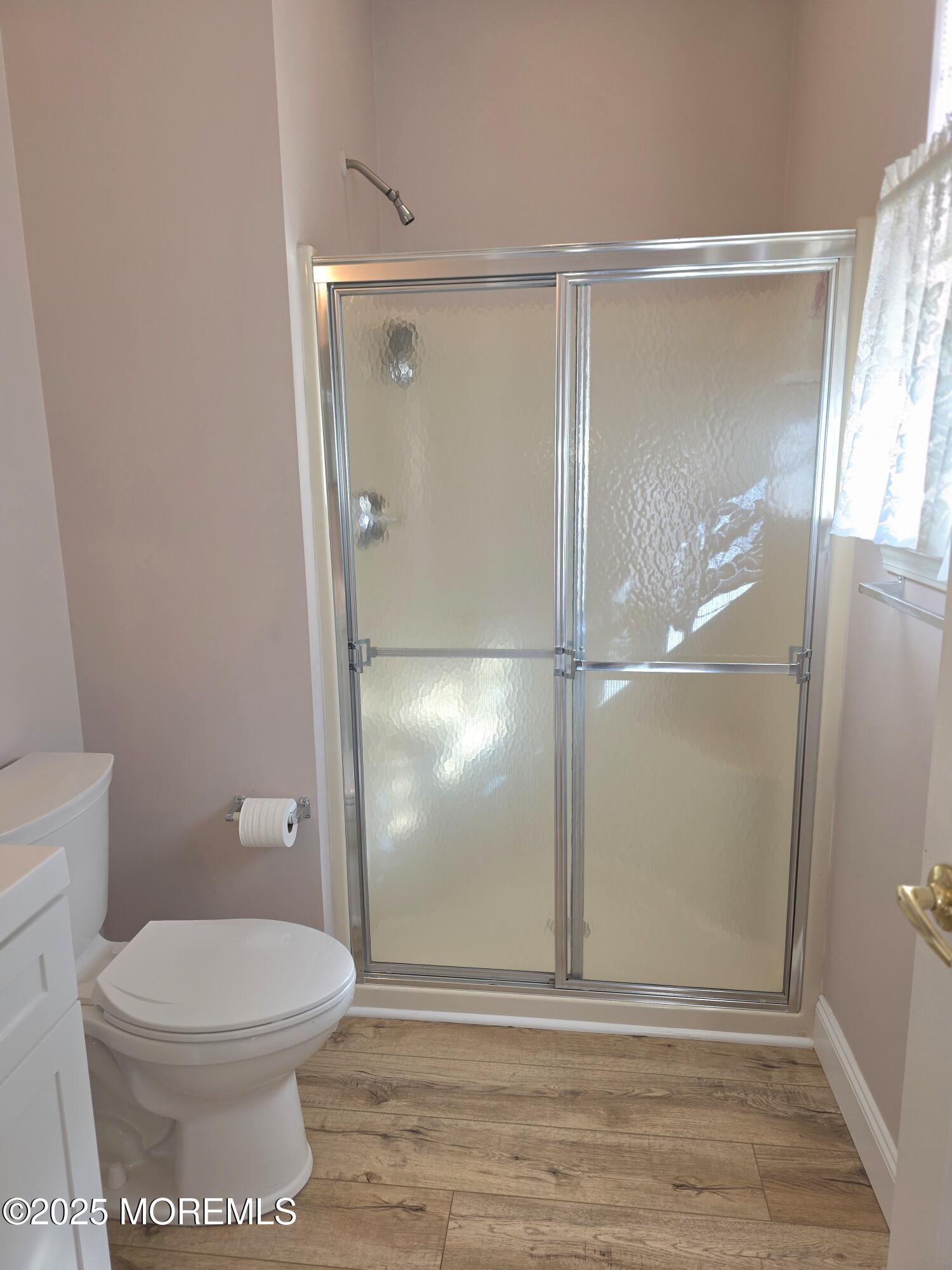 61 Sandpiper Road Barnegat, NJ 08005 - Photo 33 of 44 a bathroom with a toilet and a glass shower door