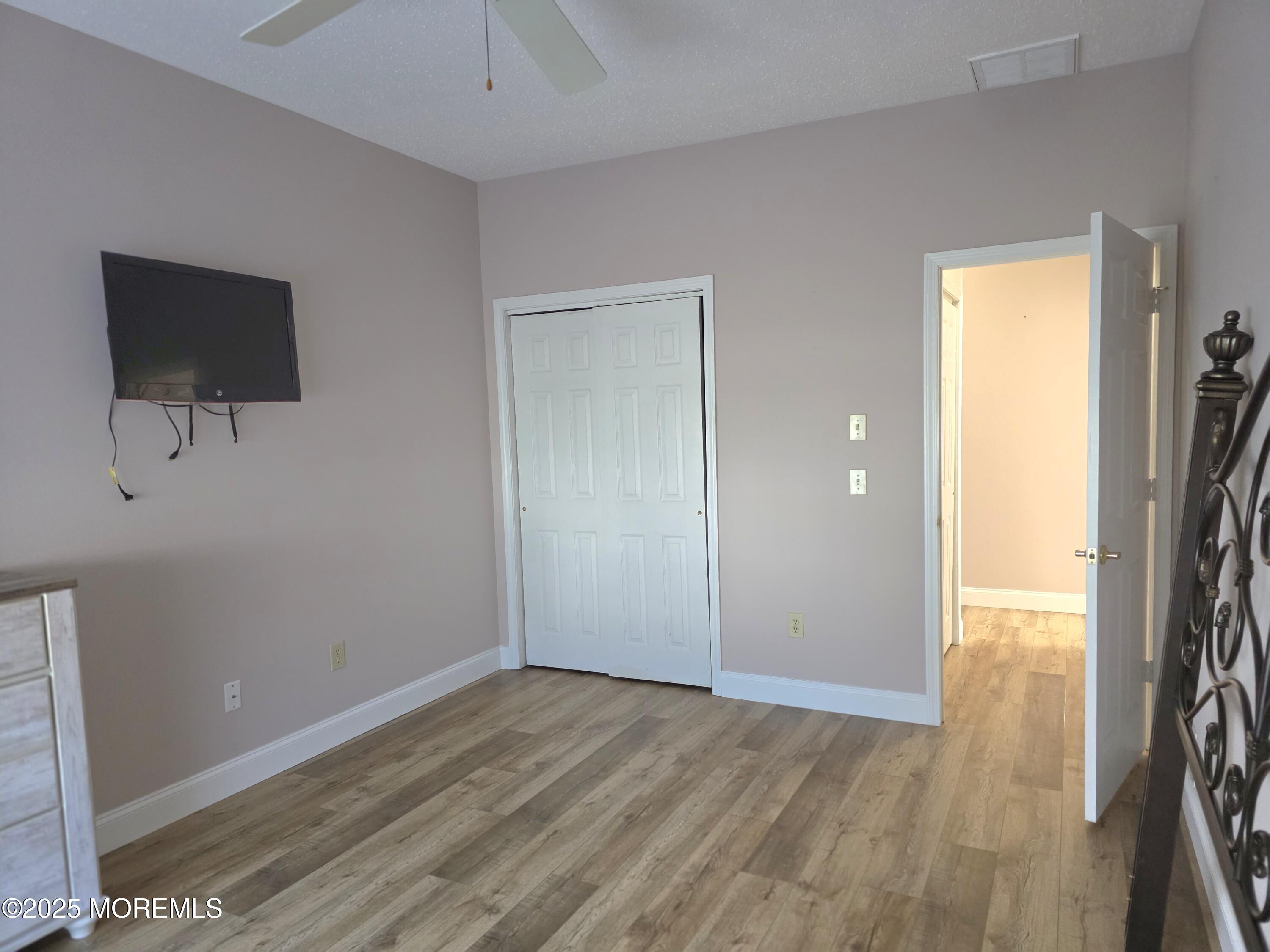 61 Sandpiper Road Barnegat, NJ 08005 - Photo 36 of 44 a view of an empty room with wooden floor and a window