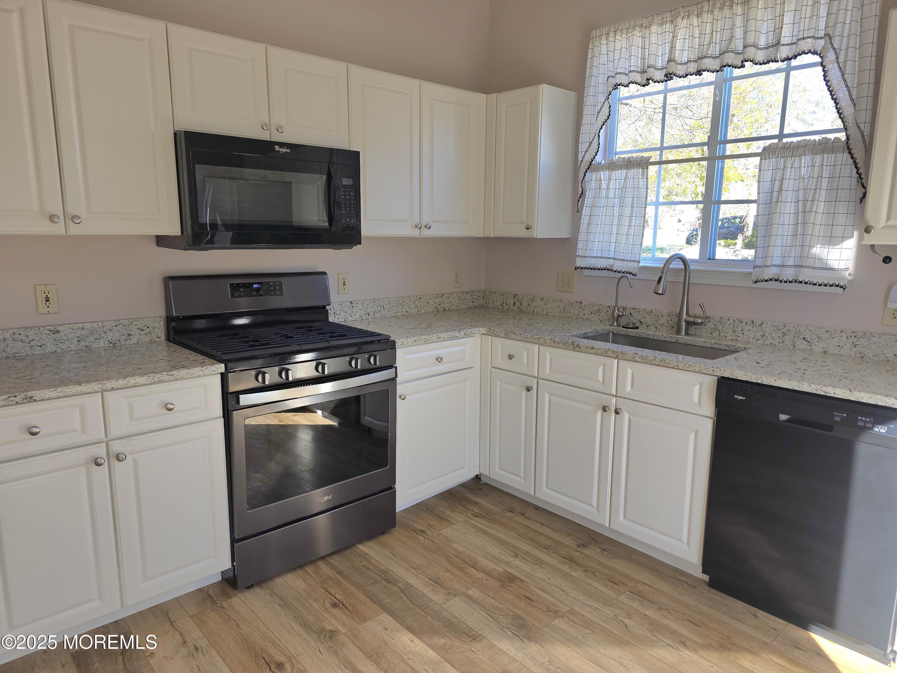 61 Sandpiper Road Barnegat, NJ 08005 - Photo 8 of 44 a kitchen with granite countertop a stove a sink and a microwave
