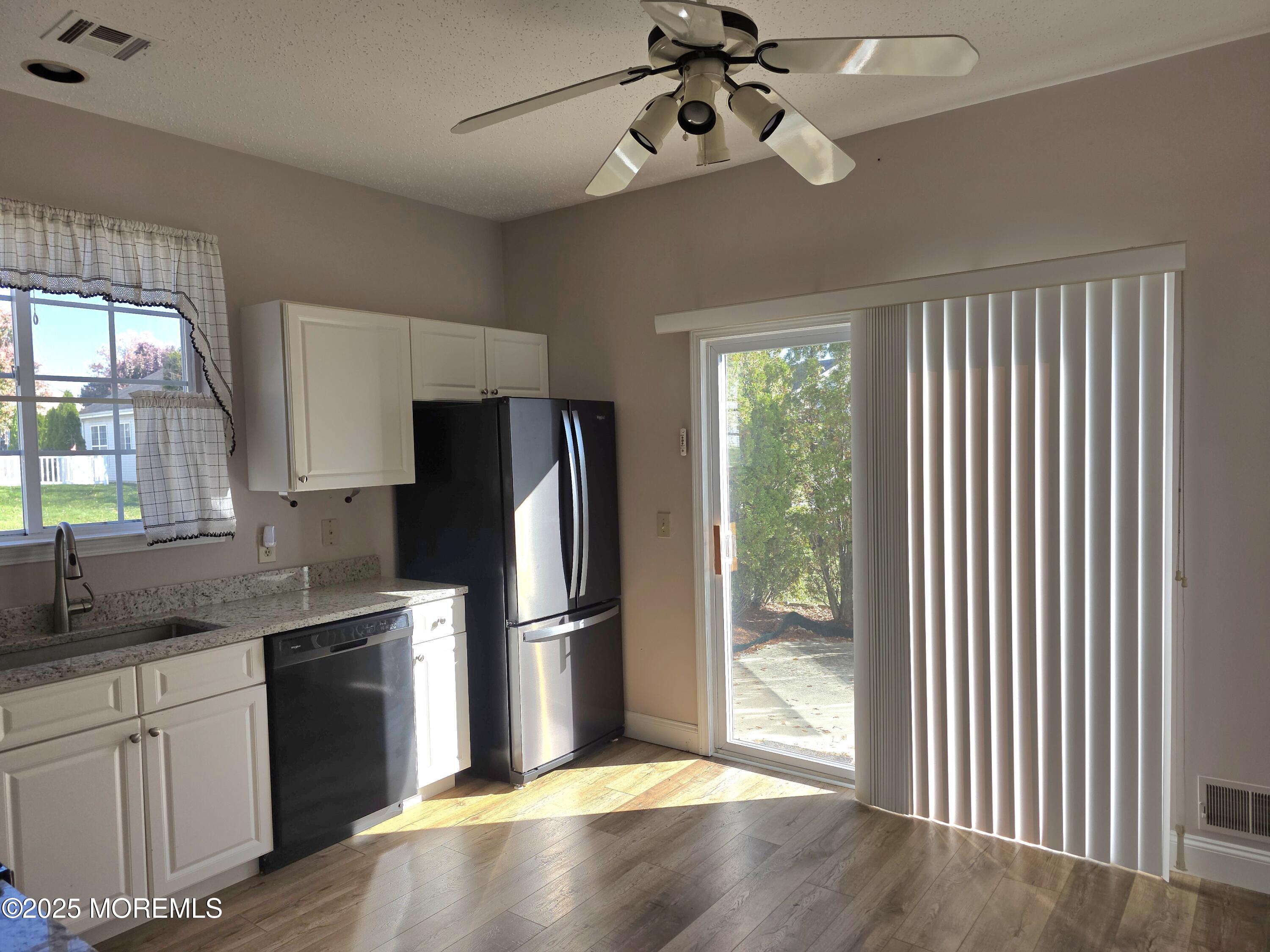 61 Sandpiper Road Barnegat, NJ 08005 - Photo 9 of 44 a kitchen with kitchen island wooden floor center island and stainless steel appliances