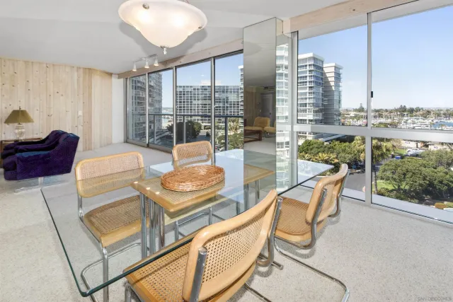 a living room with furniture and a floor to ceiling window