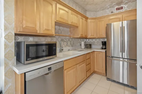 a kitchen with appliances cabinets and a sink