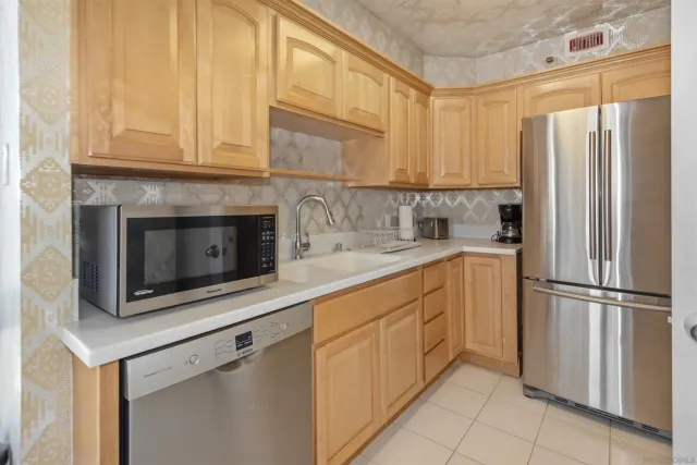 a kitchen with appliances cabinets and a sink
