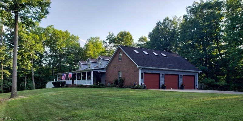 2002 Laurel Ridge Road Culloden, WV 25510 - Photo 2 of 36 View of home's exterior with a garage and a lawn