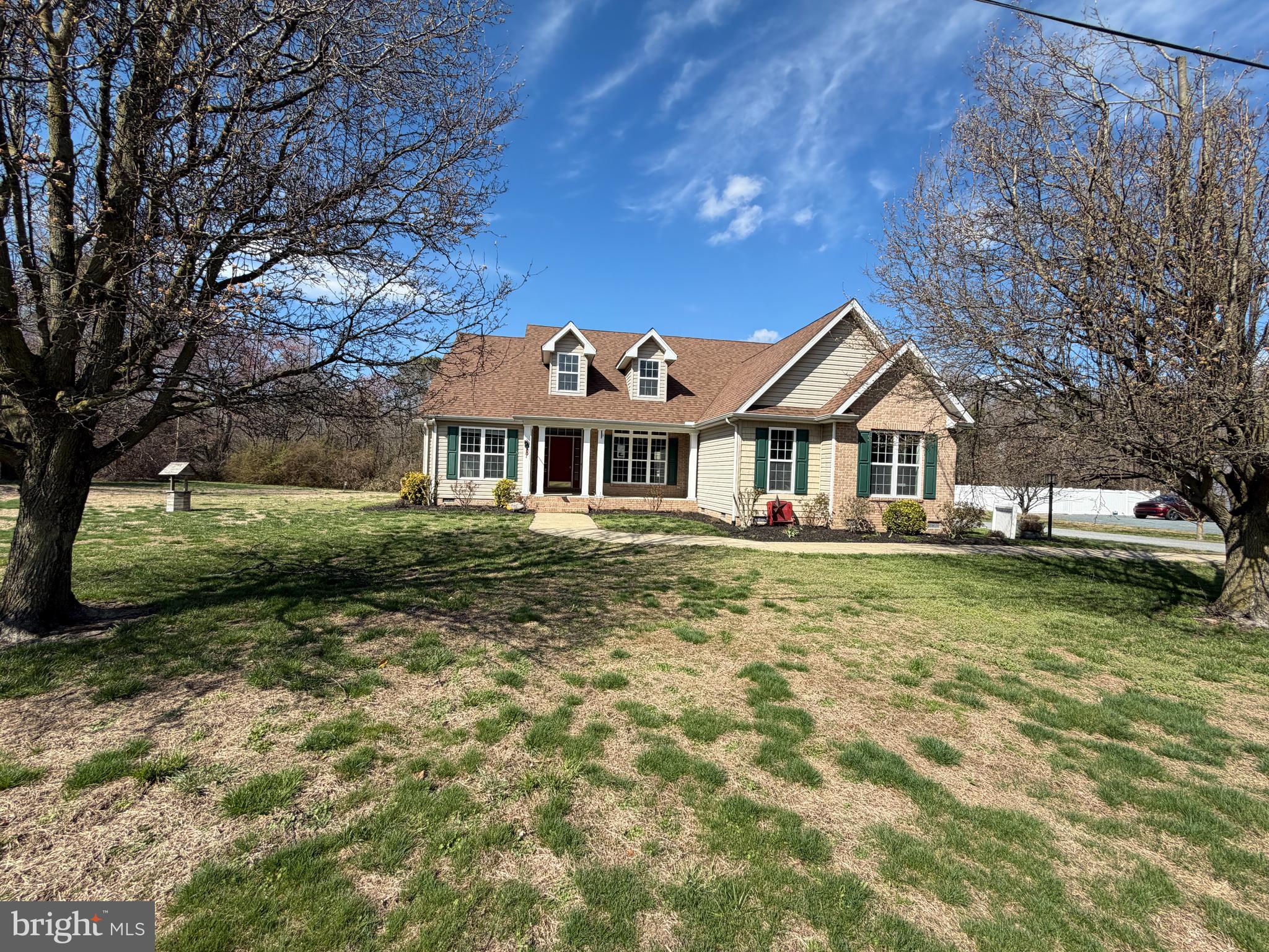8617 Portsville Road Laurel, DE 19956 - Photo 2 of 47 a front view of a house with a garden