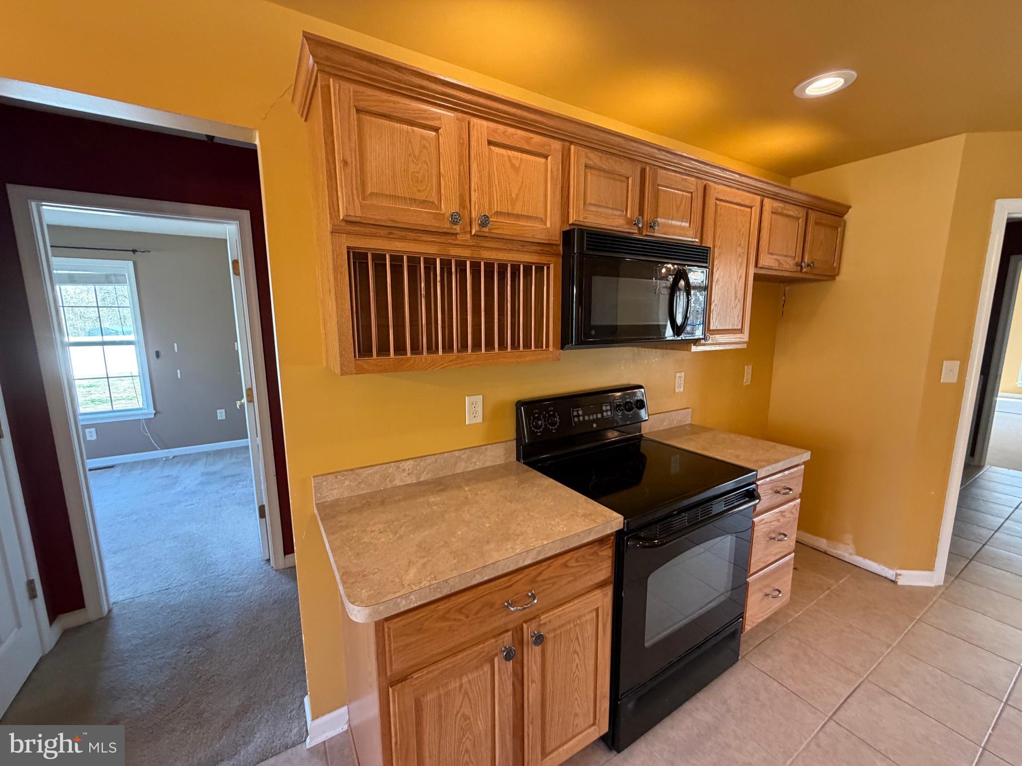 8617 Portsville Road Laurel, DE 19956 - Photo 29 of 47 a kitchen with granite countertop a stove and a refrigerator