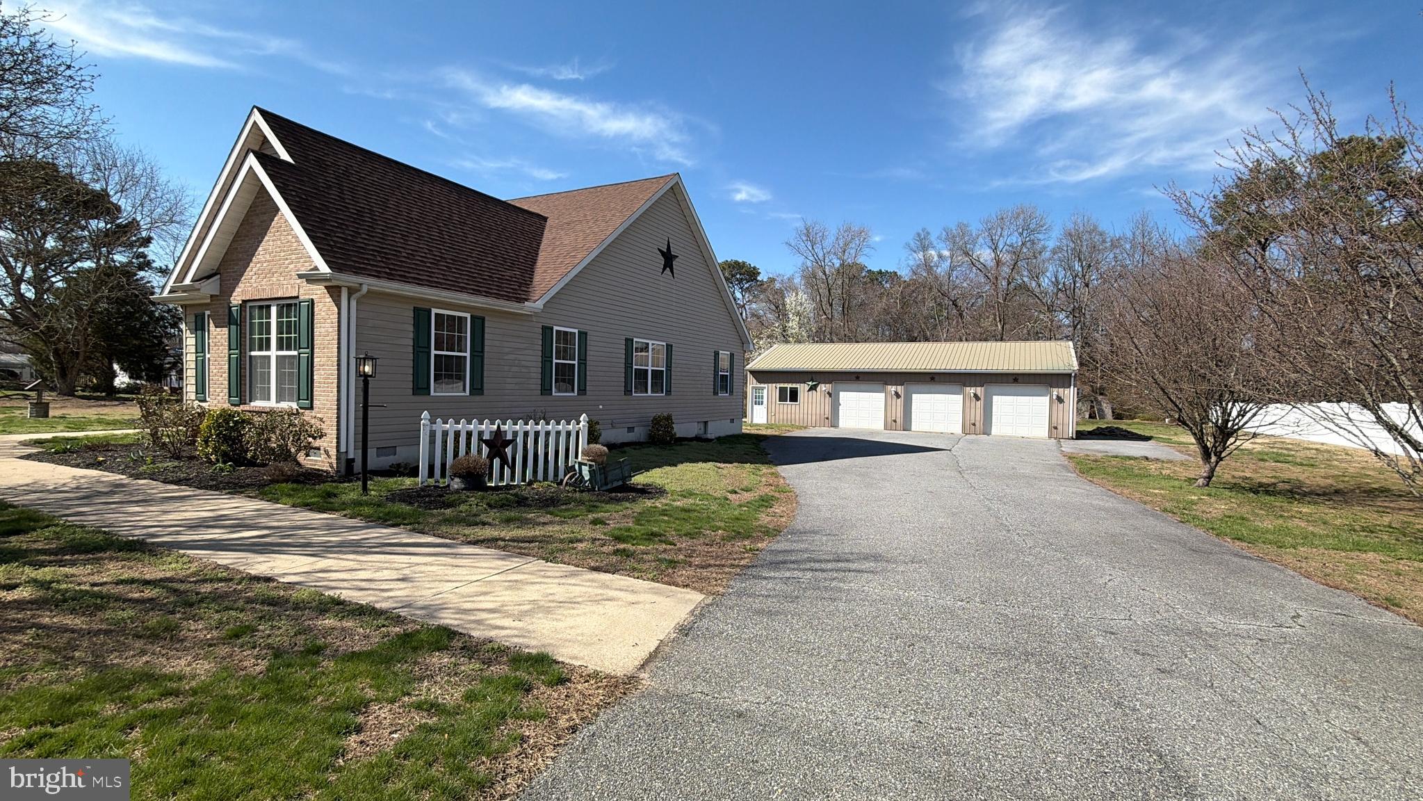 8617 Portsville Road Laurel, DE 19956 - Photo 4 of 47 a front view of a house with a yard and garage