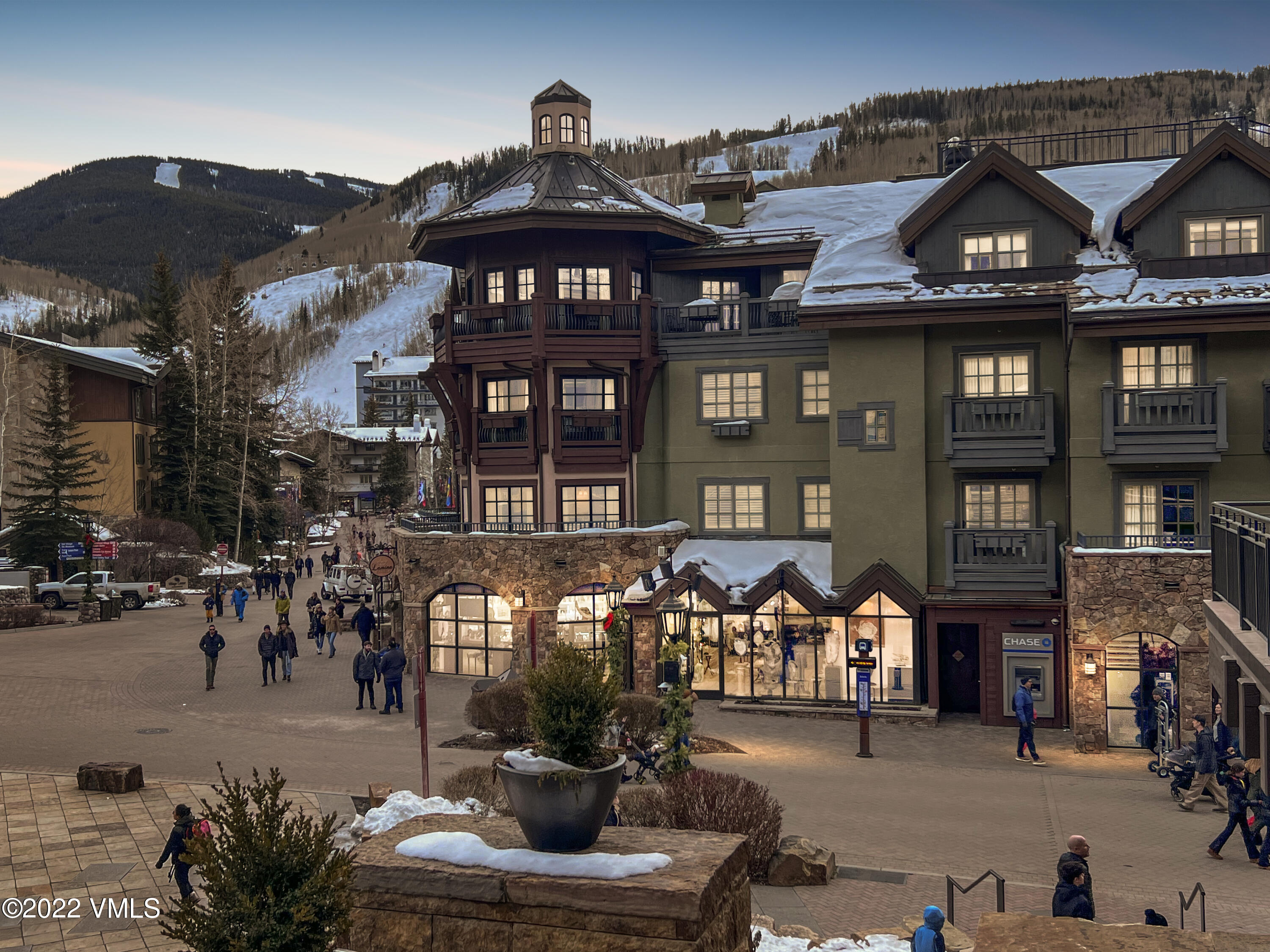 a front view of a building with retail shop and outdoor seating
