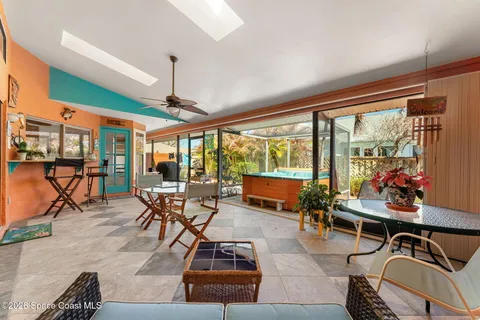 a dining room with furniture a window and wooden floor