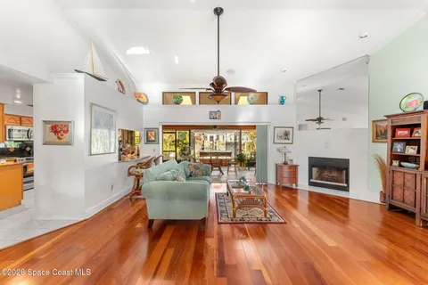 a view of a dining room with furniture water view and large windows
