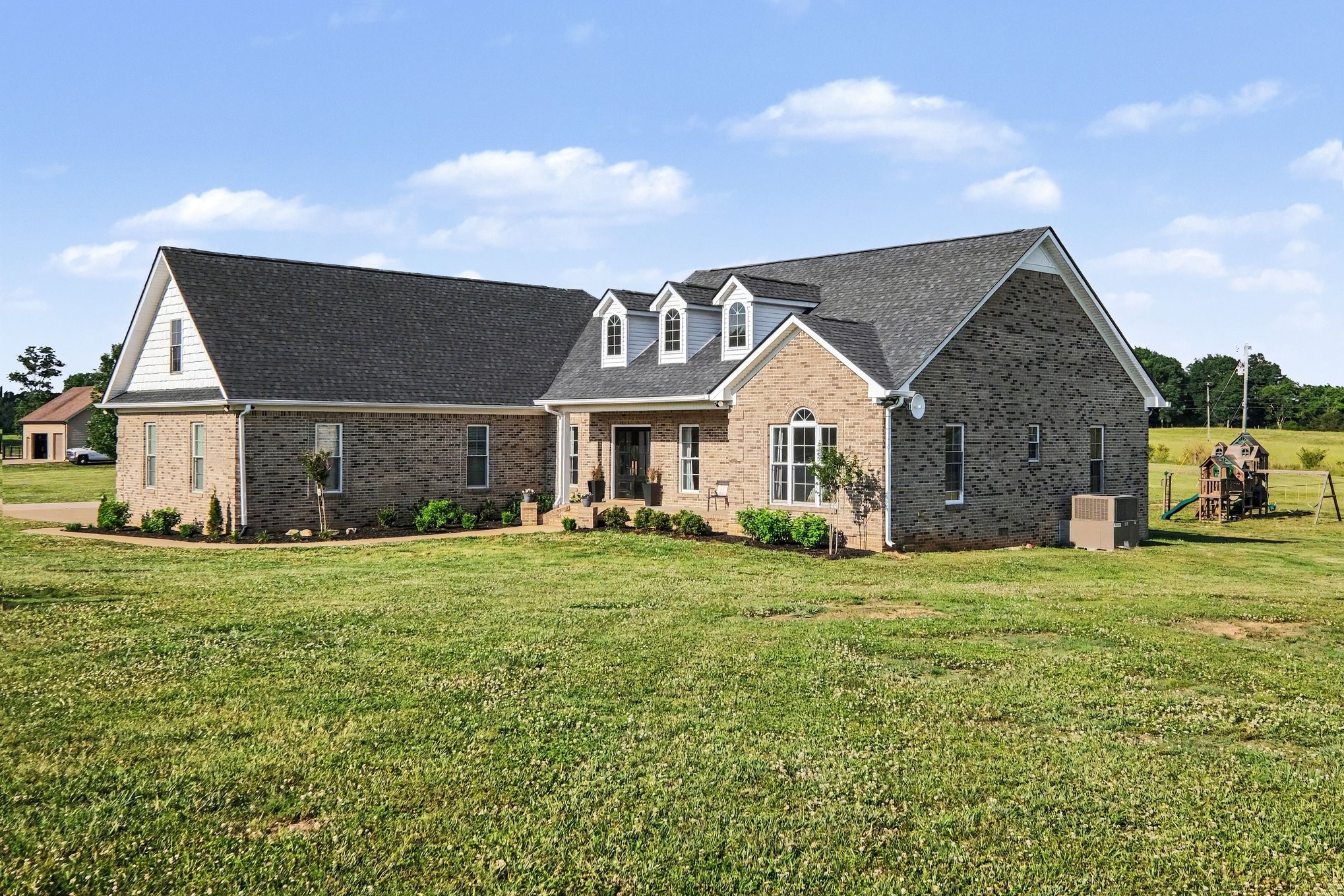 2829 Anes Station Road Lewisburg, TN 37091 - Photo 3 of 43 a front view of a house with a garden and yard
