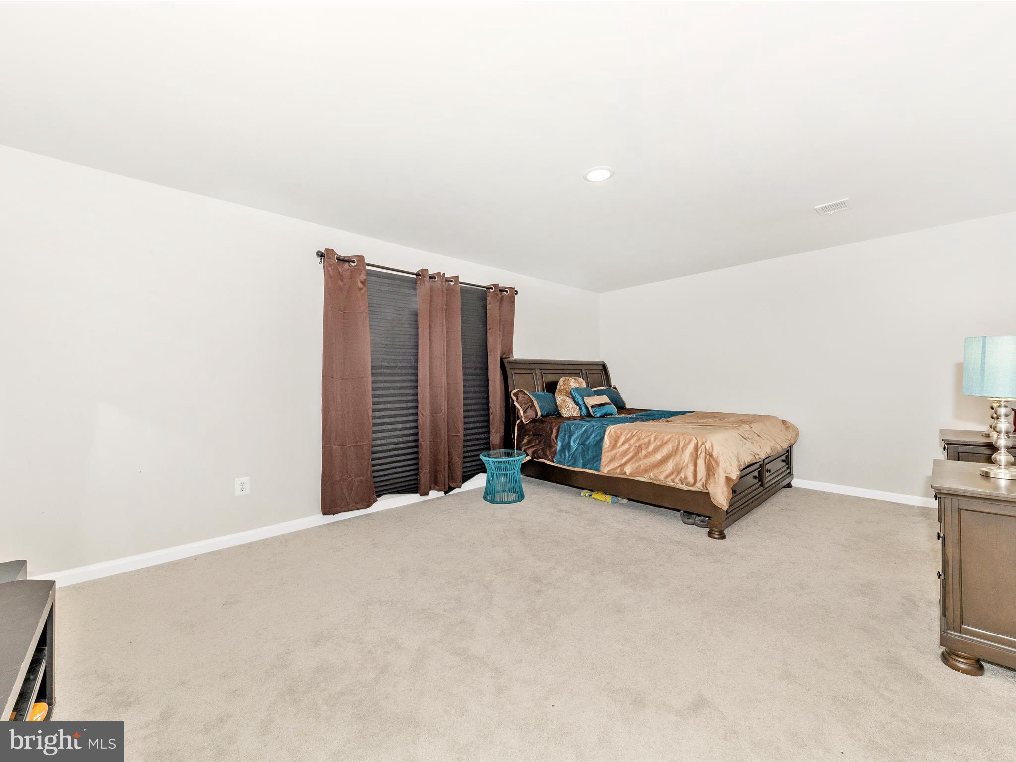 76 Diving Scaup Road Hedgesville, WV 25427 - Photo 22 of 41 a bedroom with a bed and a night stand