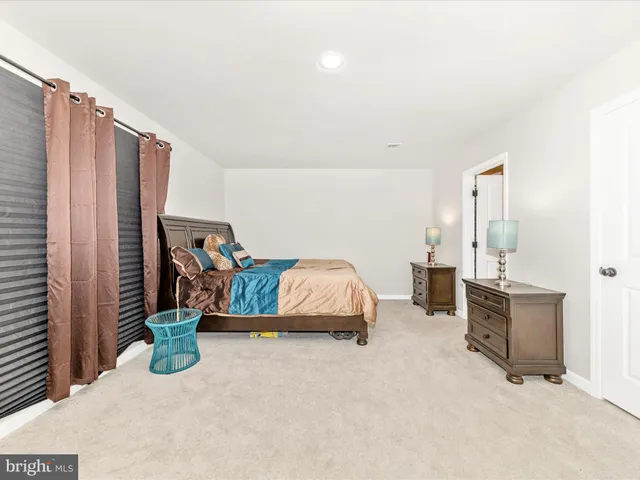 a bedroom with furniture and a tub