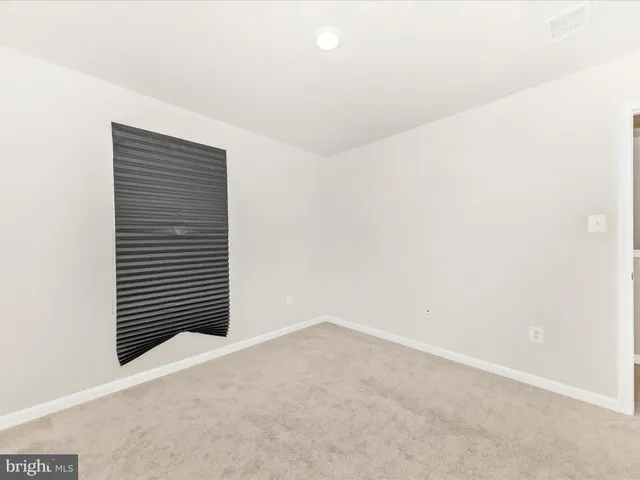 a bathroom with double vanity sink a mirror and a shower