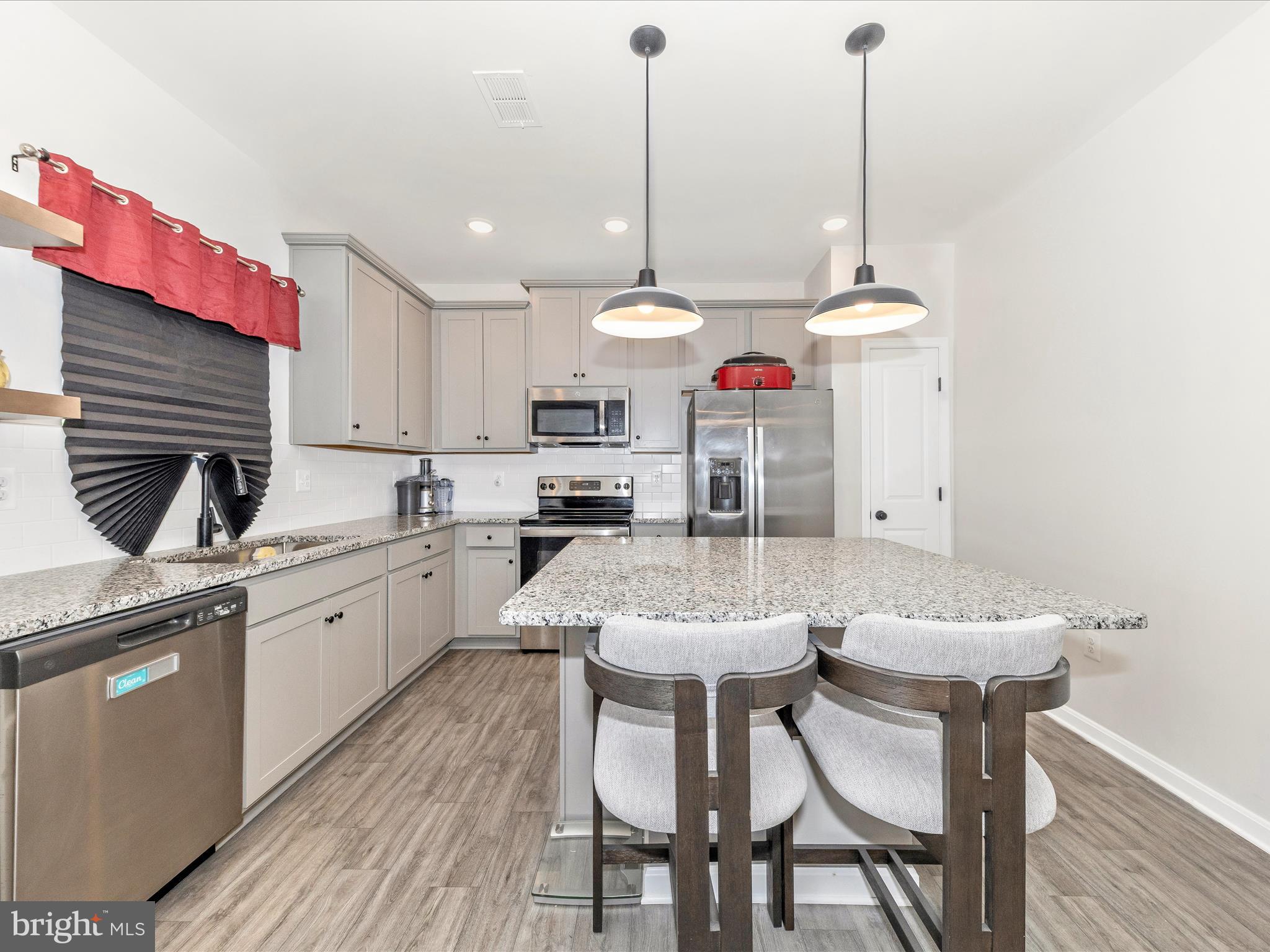 76 Diving Scaup Road Hedgesville, WV 25427 - Photo 5 of 41 a kitchen with a dining table chairs sink and cabinets