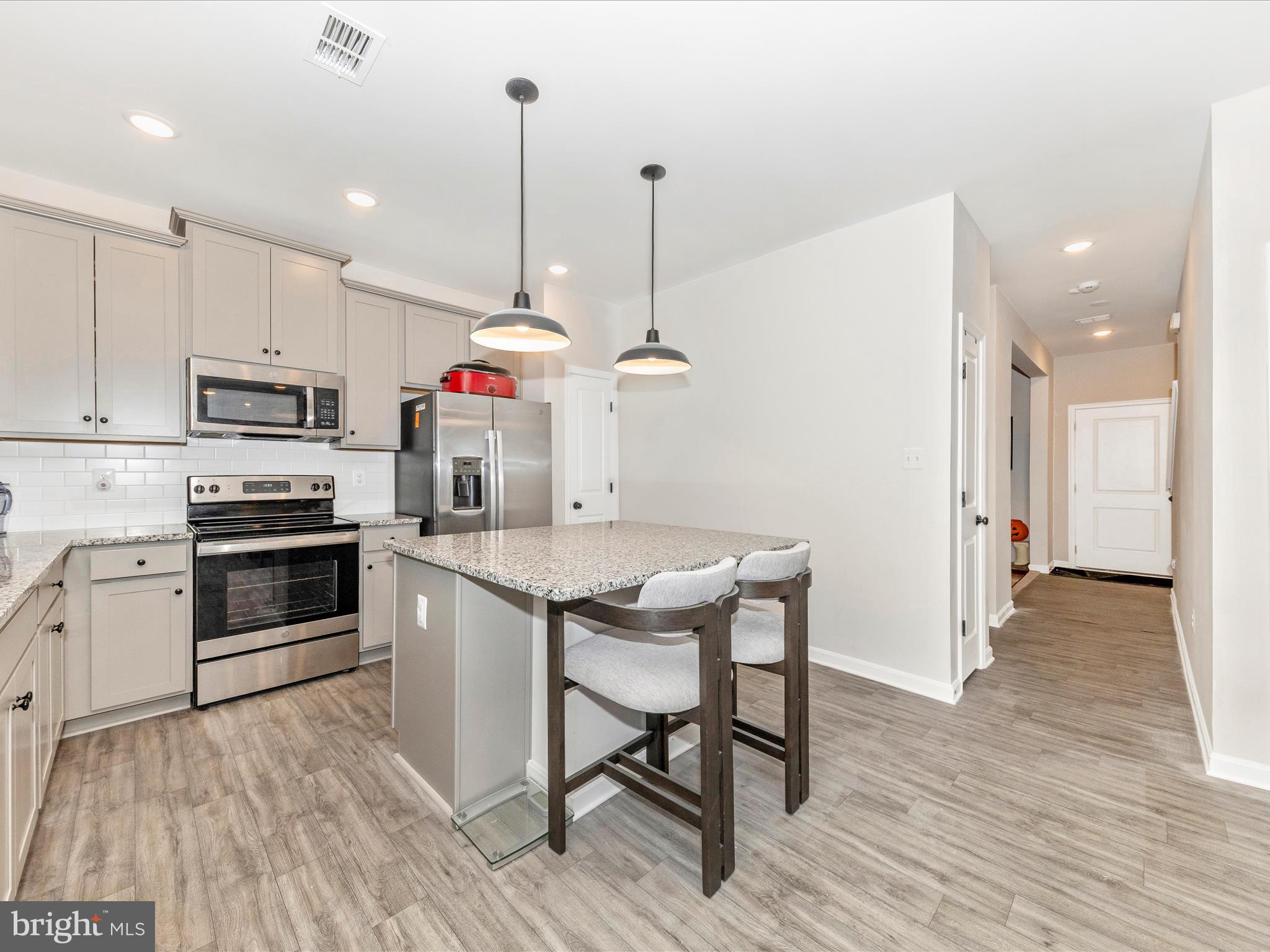 76 Diving Scaup Road Hedgesville, WV 25427 - Photo 6 of 41 a kitchen with wooden floor and white appliances
