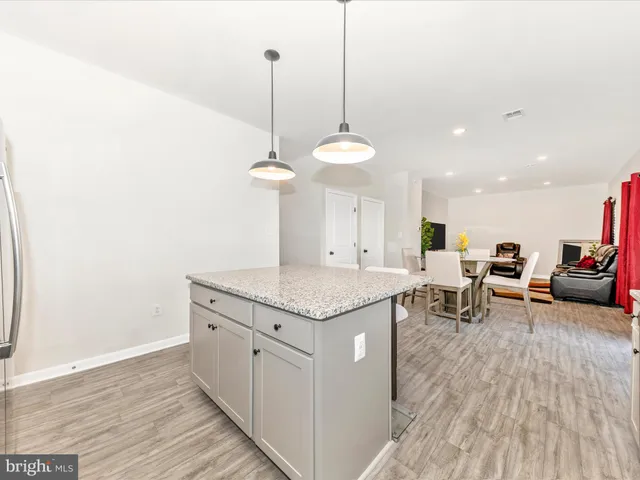 a kitchen with stainless steel appliances granite countertop a stove a sink and a wooden floors