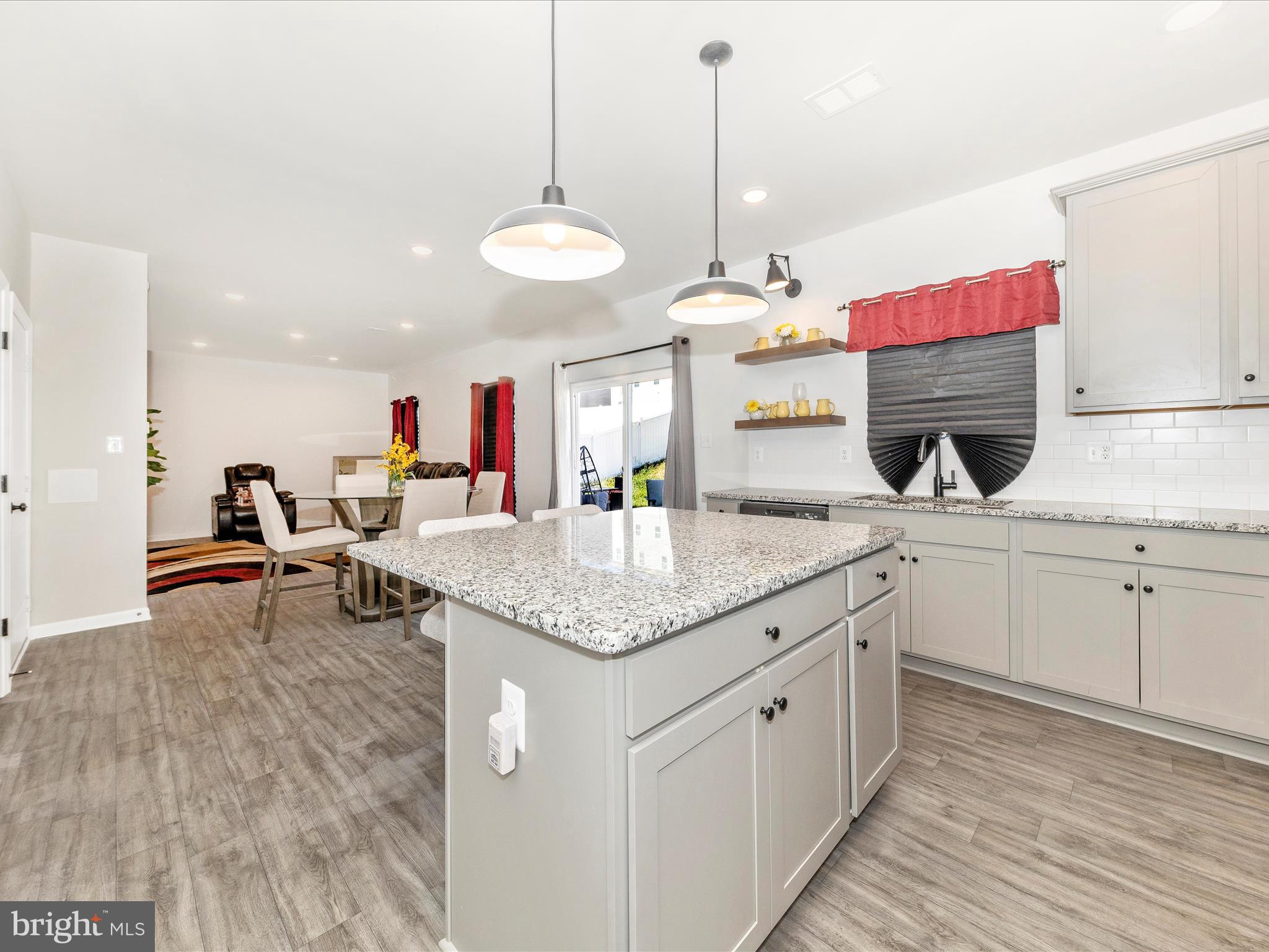 76 Diving Scaup Road Hedgesville, WV 25427 - Photo 8 of 41 a kitchen with stainless steel appliances granite countertop a sink dishwasher and white cabinets with wooden floor