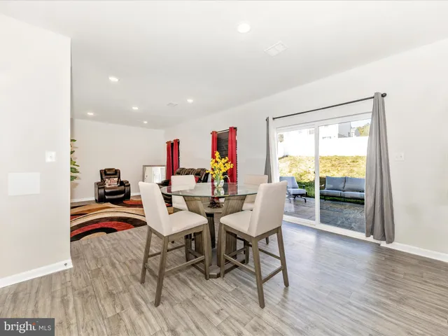 a dining room with furniture and wooden floor