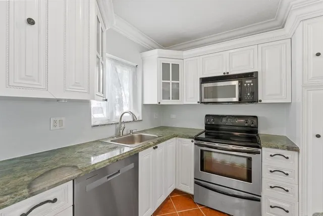 a bedroom with a bed and large window