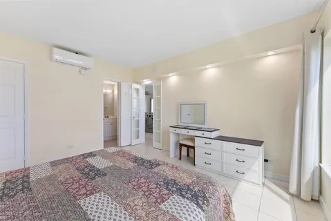 a bathroom with a shower sink mirror and toilet