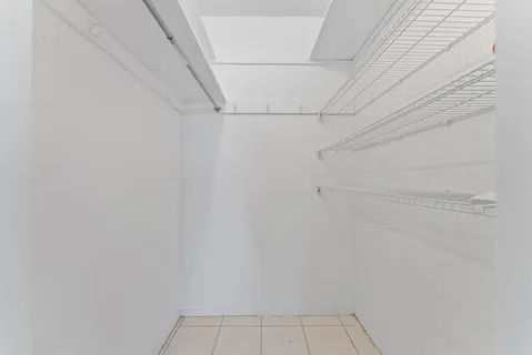 a view of a livingroom with furniture and chandelier fan