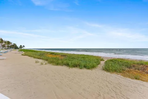 a view of a chairs and table in backyard of the house