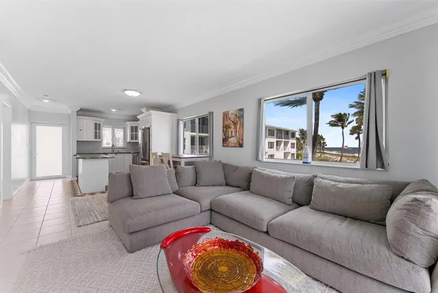 a kitchen with a dining table chairs and refrigerator