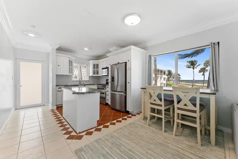 a large kitchen with stainless steel appliances granite countertop a stove a sink dishwasher and a refrigerator